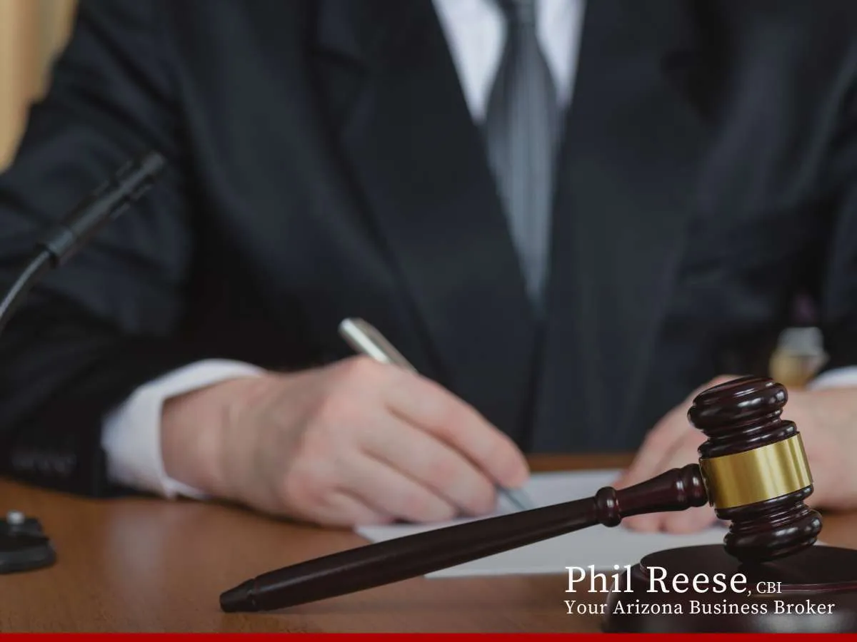 Business broker reviewing documents with a gavel on the table, keyword: Business’s Financials
